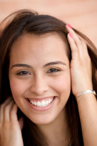 Beautiful-hispanic-woman-smiling-with-hand-in-hair