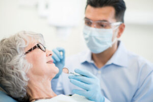A senior citizen in the dental chair ready for a routine checkup.