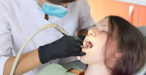 A woman receives a comfortable teeth cleaning with sedation dentistry.